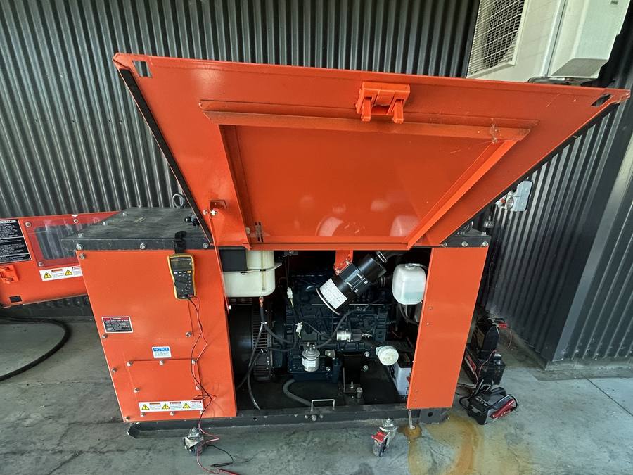 Generator with its canopy raised for servicing